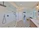Modern bathroom with glass shower, patterned tile floor, and view into bedroom at 945 Bunker View Dr, Apollo Beach, FL 33572