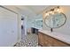 Modern bathroom with a large vanity, a backlit mirror, and a walk-in shower, boasting sleek finishes and stylish design at 945 Bunker View Dr, Apollo Beach, FL 33572