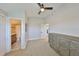 Neutral bedroom with gray dresser and a glimpse into a modern bathroom at 945 Bunker View Dr, Apollo Beach, FL 33572