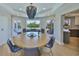 Dining room with round wooden table, seating for six, and access to outdoor seating areas at 945 Bunker View Dr, Apollo Beach, FL 33572