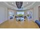 The dining room boasts access to the patio through the double doors, with backyard and tree views through large windows at 945 Bunker View Dr, Apollo Beach, FL 33572