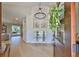 A grand foyer featuring high ceilings, a modern chandelier, and light, wood-look floors at 945 Bunker View Dr, Apollo Beach, FL 33572