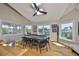 A game room with multiple windows, a poker table, a ceiling fan, and a view of the waterfront at 945 Bunker View Dr, Apollo Beach, FL 33572
