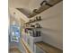 Stylish hallway featuring custom shelving and seating nook at 945 Bunker View Dr, Apollo Beach, FL 33572
