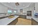 Modern kitchen with stainless steel appliances, custom cabinets, and a large center island at 945 Bunker View Dr, Apollo Beach, FL 33572