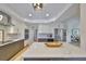 A modern kitchen boasts stainless steel appliances, gray lower cabinets, white upper cabinets, and a large marble island at 945 Bunker View Dr, Apollo Beach, FL 33572