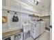 Bright laundry room featuring a sink and front loading washer and dryer at 945 Bunker View Dr, Apollo Beach, FL 33572
