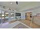 Open-concept living room with view to the pool and staircase to the second level at 945 Bunker View Dr, Apollo Beach, FL 33572