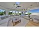 Cozy living room featuring large windows, a skylight, ceiling fan and an open view of the pool at 945 Bunker View Dr, Apollo Beach, FL 33572