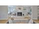 Bright living room featuring a fireplace and mantel flanked by window seats at 945 Bunker View Dr, Apollo Beach, FL 33572