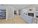Bright and airy living room with fireplace, wood floors, and staircase at 945 Bunker View Dr, Apollo Beach, FL 33572