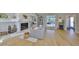 Bright living room featuring a fireplace, hardwood floors, and an open floor plan to the dining room at 945 Bunker View Dr, Apollo Beach, FL 33572