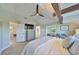 Expansive main bedroom with en-suite bathroom access, decorated with a ceiling fan and modern furnishings at 945 Bunker View Dr, Apollo Beach, FL 33572