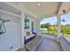 Comfortable covered patio with outdoor shower, seating area, and fire pit, ideal for enjoying the outdoors at 945 Bunker View Dr, Apollo Beach, FL 33572
