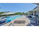 Beautiful pool area with seating, umbrellas, and bay views, perfect for relaxation and entertaining guests at 945 Bunker View Dr, Apollo Beach, FL 33572