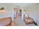 Inviting sitting area adjacent to main bedroom, featuring comfortable seating and stylish decor at 945 Bunker View Dr, Apollo Beach, FL 33572