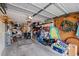 Cluttered garage with overhead storage and a variety of stored items at 9511 45Th N St # 9511, Pinellas Park, FL 33782