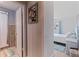 Hallway view of a bathroom and a bedroom with light-colored walls and light wood-look floors at 9511 45Th N St # 9511, Pinellas Park, FL 33782