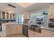Charming kitchen with stainless steel appliances, white cabinets, and an open layout to the living room at 9511 45Th N St # 9511, Pinellas Park, FL 33782