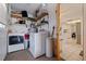 Laundry room with stacked washer and dryer, storage shelves, and view to kitchen at 9511 45Th N St # 9511, Pinellas Park, FL 33782