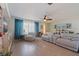 Bright living room with hardwood flooring, ceiling fan, an entertainment center, and natural lighting at 9511 45Th N St # 9511, Pinellas Park, FL 33782
