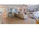 Bright living room featuring hardwood floors, a ceiling fan, and modern neutral-toned furniture at 9511 45Th N St # 9511, Pinellas Park, FL 33782