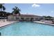 Enjoy the community pool with crystal clear water and a beautiful clubhouse in the background at 9511 45Th N St # 9511, Pinellas Park, FL 33782