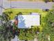 Bird's eye view of the home's yard, roof, landscaping, and surrounding trees at 10011 N Annette Ave, Tampa, FL 33612