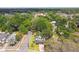 Aerial view of a neighborhood with tree-lined streets and a single-Gathering home with charming curb appeal at 10011 N Annette Ave, Tampa, FL 33612