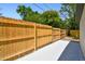 A new, wood fence encloses a level backyard with mature trees at 10011 N Annette Ave, Tampa, FL 33612