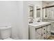Modern bathroom featuring a double vanity with vessel sinks, illuminated mirrors, and marble-tiled shower at 10011 N Annette Ave, Tampa, FL 33612