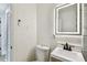 This bathroom is equipped with a illuminated mirror, a modern vanity, and a toilet at 10011 N Annette Ave, Tampa, FL 33612