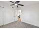 A cozy bedroom offers a ceiling fan, neutral carpet, and an abundance of natural light at 10011 N Annette Ave, Tampa, FL 33612