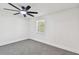 Bedroom with gray carpet flooring, white walls, and natural light from a window at 10011 N Annette Ave, Tampa, FL 33612