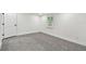 This bedroom features gray carpet, a bright window, and a white door at 10011 N Annette Ave, Tampa, FL 33612