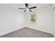 A cozy bedroom offers a ceiling fan, neutral carpet, and an abundance of natural light at 10011 N Annette Ave, Tampa, FL 33612