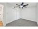Bedroom with gray carpet flooring, white walls, and white closet doors at 10011 N Annette Ave, Tampa, FL 33612