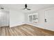 Bright bedroom featuring wood-look floors, a ceiling fan, and a closet at 10011 N Annette Ave, Tampa, FL 33612