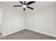 A cozy bedroom offers a ceiling fan, neutral carpet, and an abundance of natural light at 10011 N Annette Ave, Tampa, FL 33612