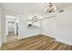 Bright dining room with stylish lighting, and wood-look floors at 10011 N Annette Ave, Tampa, FL 33612