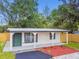 Charming home with a fresh exterior and landscaping with lush green lawn at 10011 N Annette Ave, Tampa, FL 33612