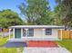 Charming home with a fresh exterior and landscaping with lush green lawn at 10011 N Annette Ave, Tampa, FL 33612