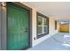 Close up of the front door, showcasing the fresh paint, door hardware, and modern window trim at 10011 N Annette Ave, Tampa, FL 33612