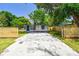 A cozy home is surrounded by newly installed wood fences, manicured lawn, and a modern driveway at 10011 N Annette Ave, Tampa, FL 33612