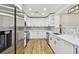 Bright kitchen featuring white cabinets, stainless steel appliances, and stylish backsplash at 10011 N Annette Ave, Tampa, FL 33612