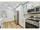 This kitchen features updated appliances, stylish cabinets, and a modern refrigerator at 10011 N Annette Ave, Tampa, FL 33612