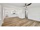 Spacious living room with sleek ceiling fan, wood flooring, and an open floor plan for versatile living at 10011 N Annette Ave, Tampa, FL 33612