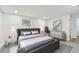 This updated main bedroom is equipped with stylish furniture and modern decor at 10011 N Annette Ave, Tampa, FL 33612
