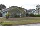 Well-maintained home with a two-car garage, manicured lawn, and mature trees in a friendly neighborhood at 10223 Tarragon Dr, Riverview, FL 33569