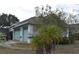 Attached two-car garage featuring light blue doors and ample parking space on a paved driveway at 10223 Tarragon Dr, Riverview, FL 33569